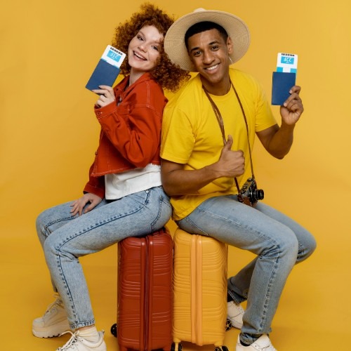 full-shot-smiley-people-sitting-baggage_Designed by Freepik